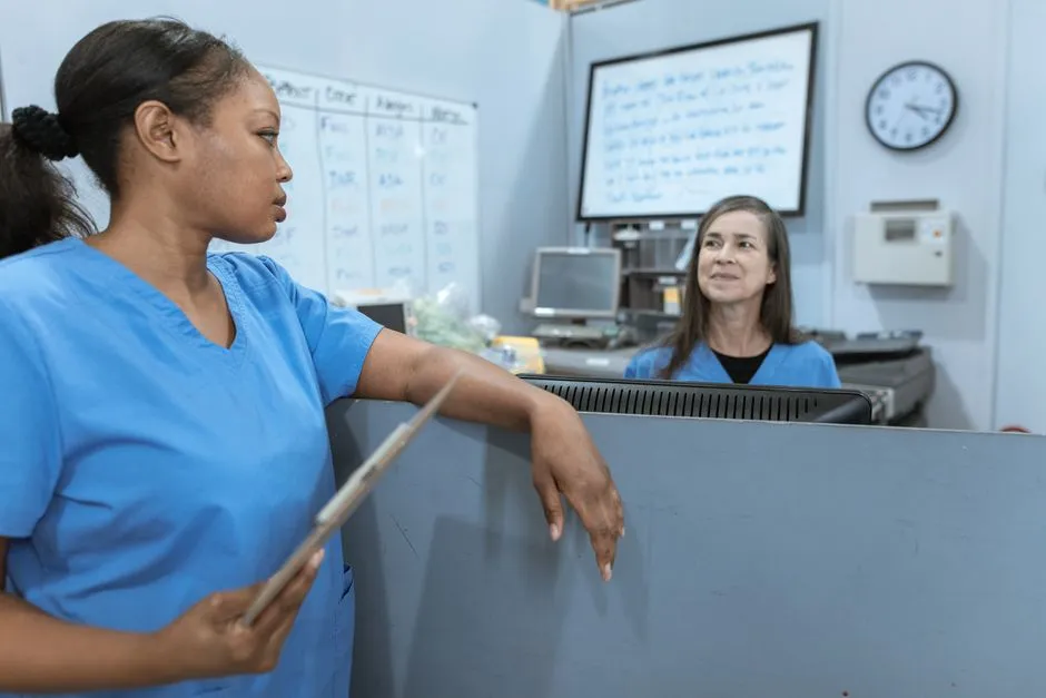 Nurse in scrubs holding a clipboard during a hospital shift